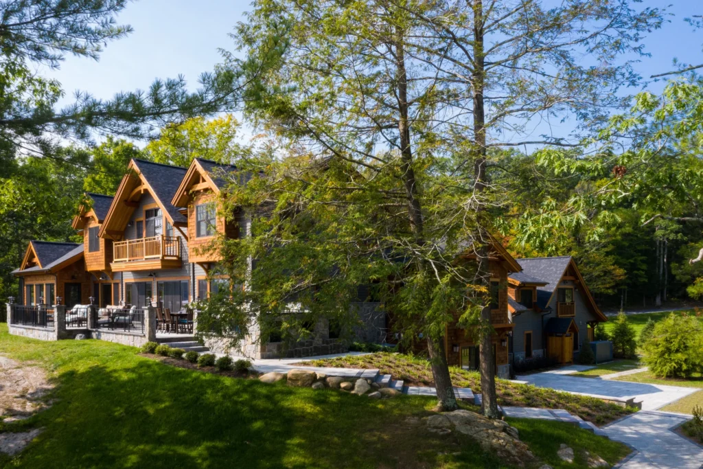 Modern wood and stone residence nestled in mature trees with designed landscape and hardscape pathways